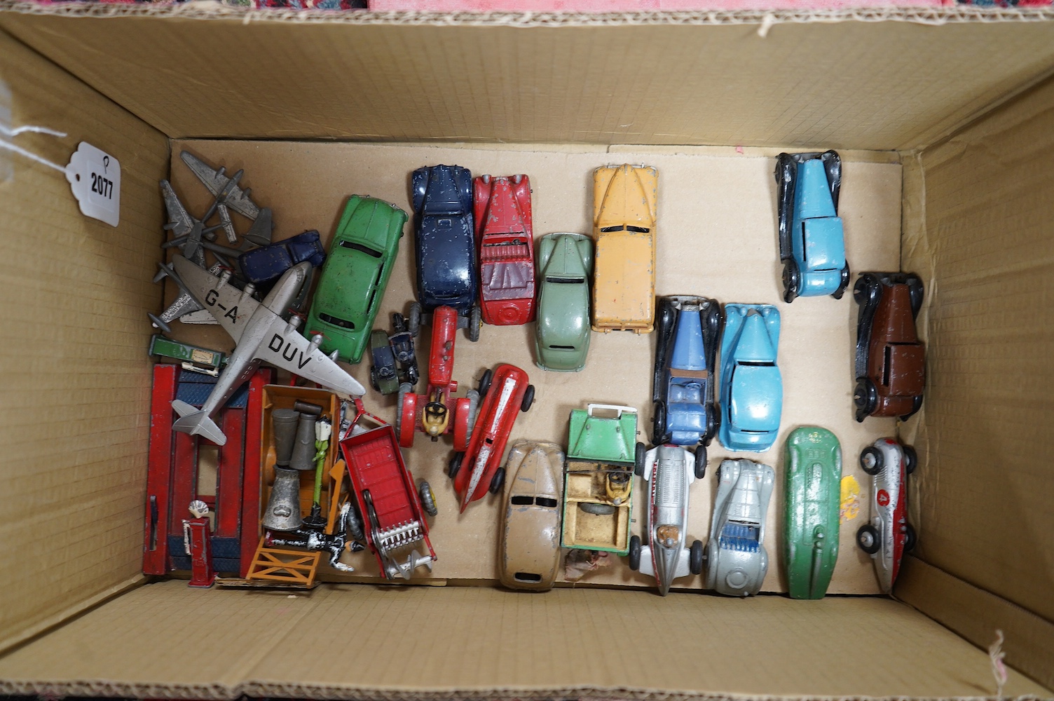 Twenty-five Dinky Toys, mainly late 1940s-50s examples including; a Triumph, Austin Devon, Austin Taxi, Sunbeam Talbot, Ford Sedan, racing cars, farm vehicles, aircraft, etc. together with a box of red and green Meccano.